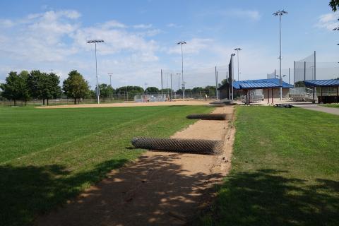 Dred Fence Replacement August 2022 with rolled up fence along the ground
