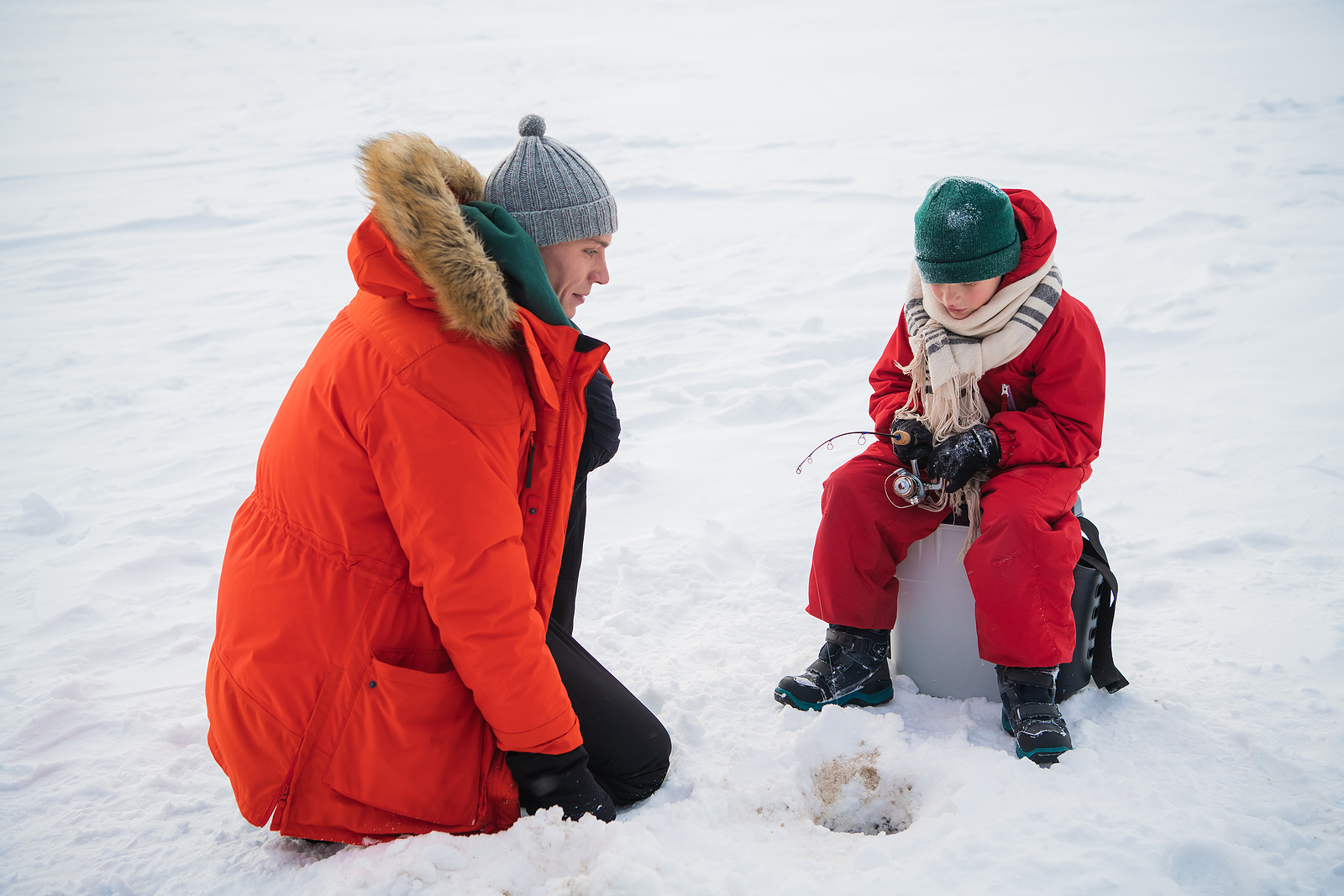 Dad and kid ice fishing