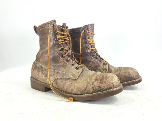 Old, worn tan-colored leather boots with loose straps