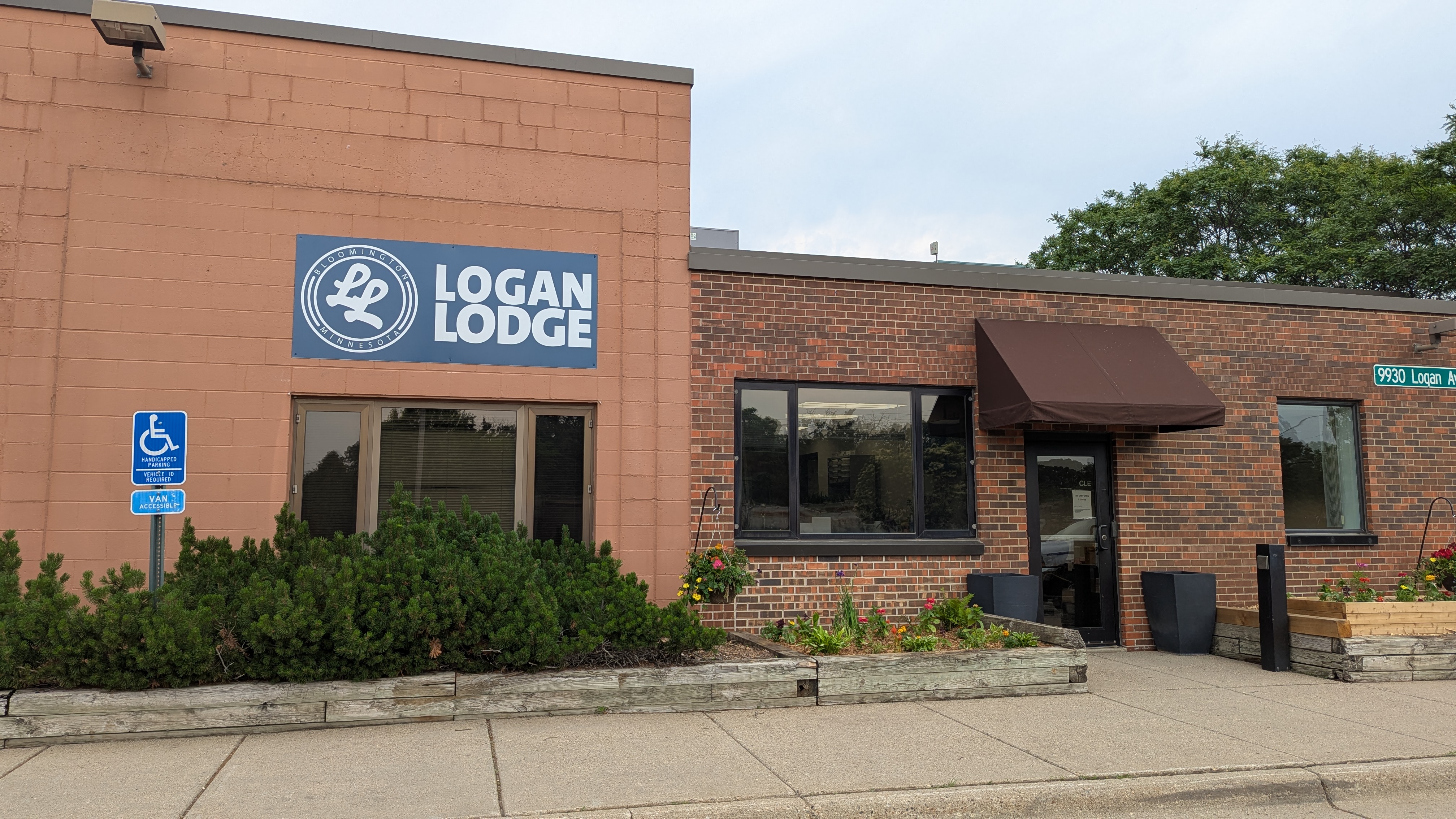 Logan Lodge brick building exterior with blue and white logo sign