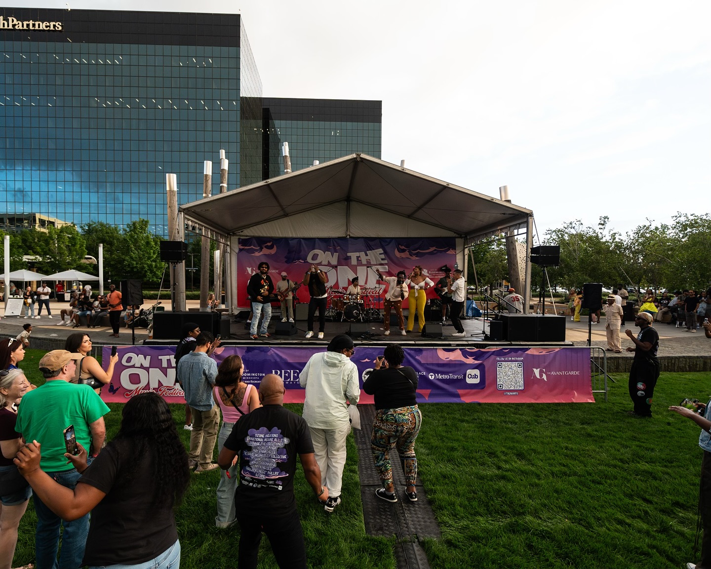 People dancing near the stage during the 2024 On The One Music Festival at Bloomington Central Station Park