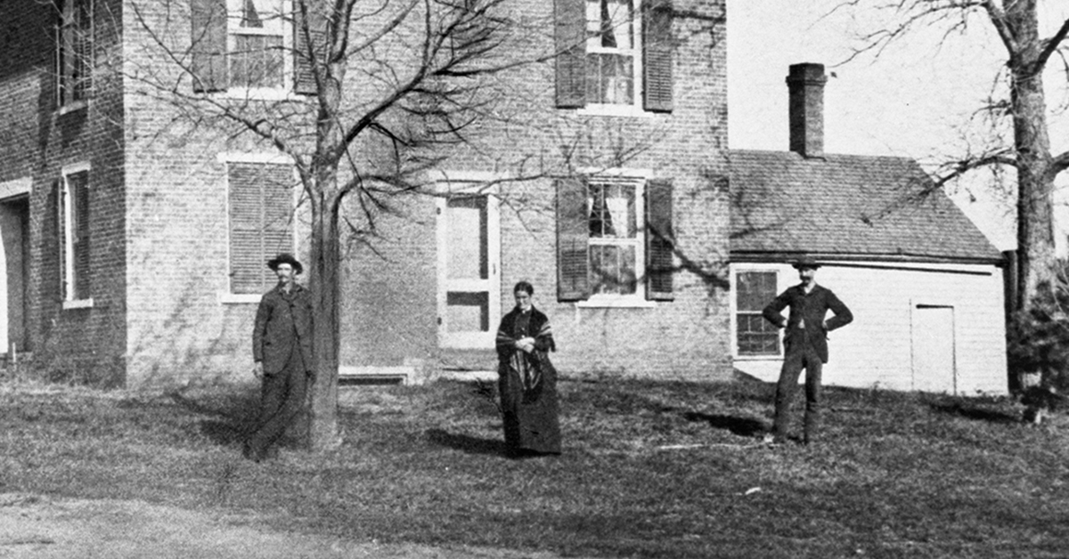 Agnes Pond and sons in mourning clothes outside the Pond House in 1878