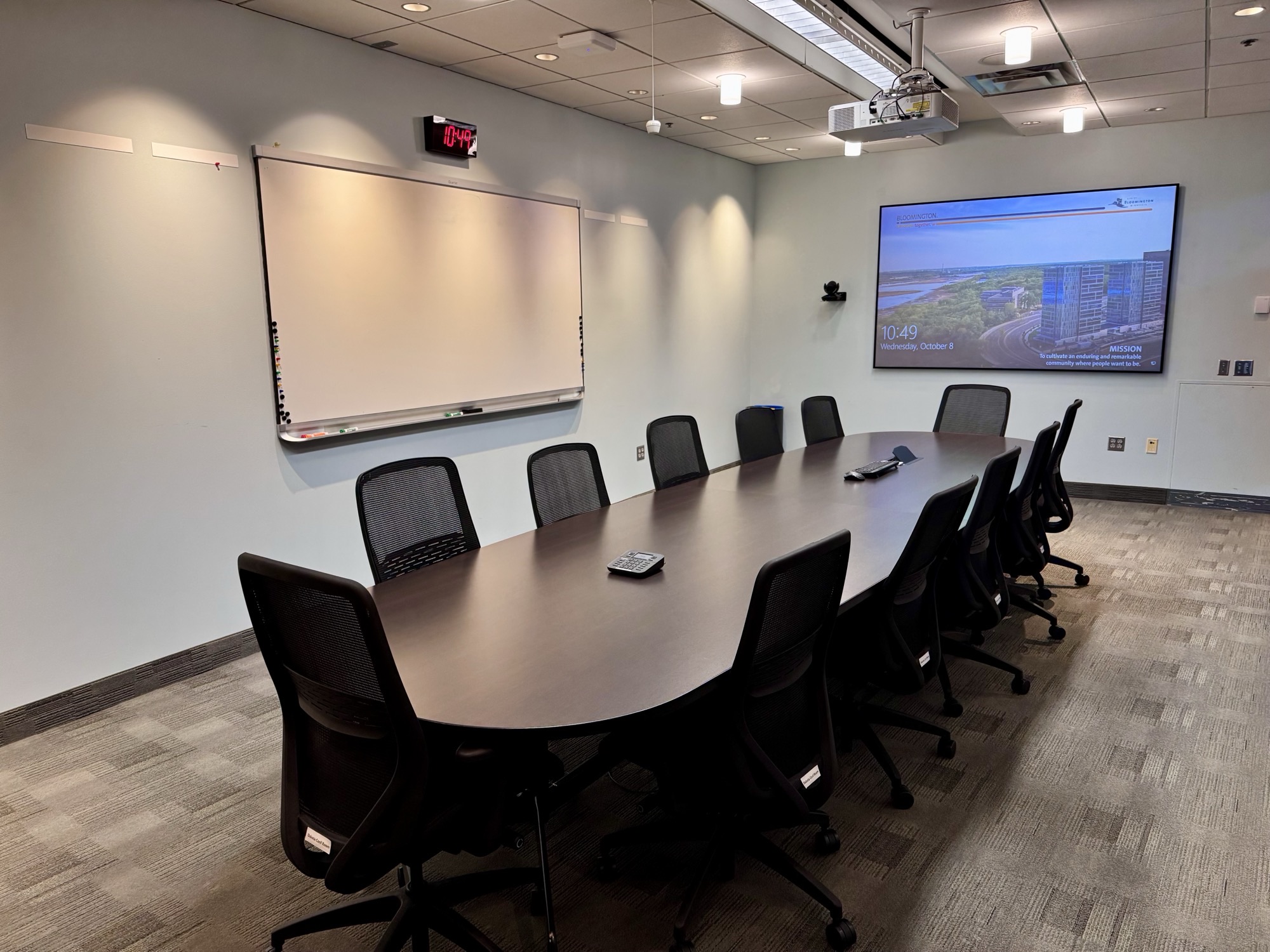Civic Plaza Dakota Conference Room October 2025 with table, chairs, projector and screen