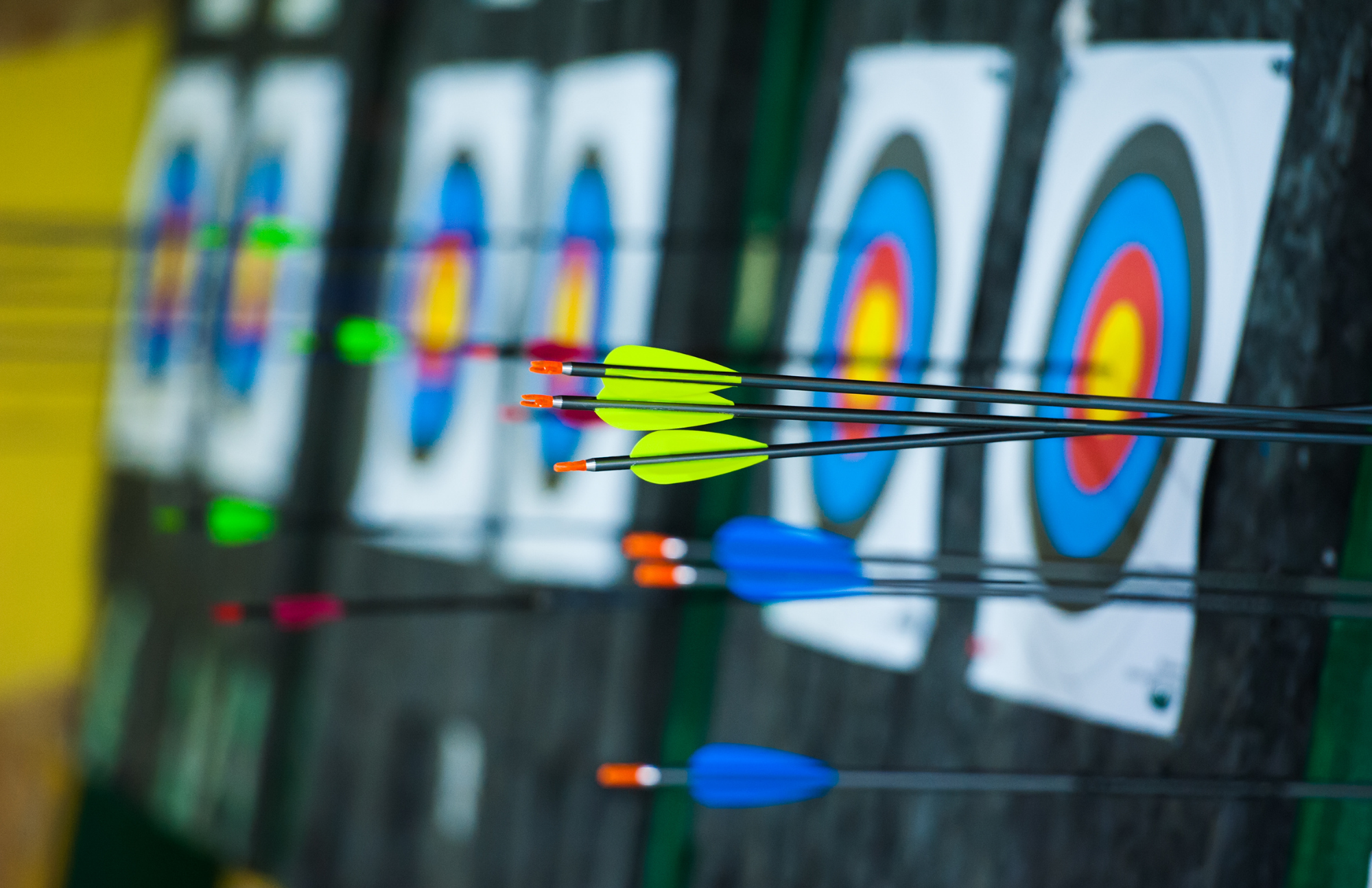 Indoor Archery with arrows sticking out of colorful round targets