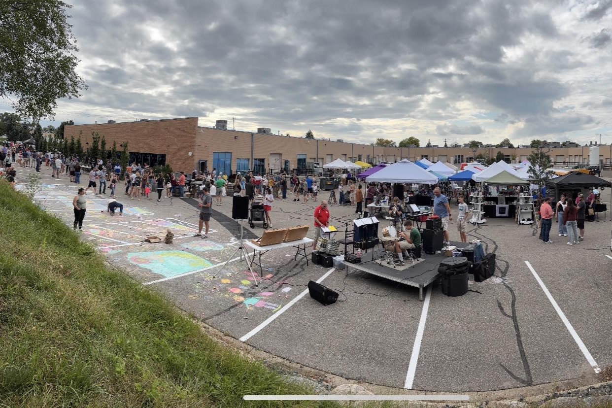 Festival in parking lot under cloudy sky