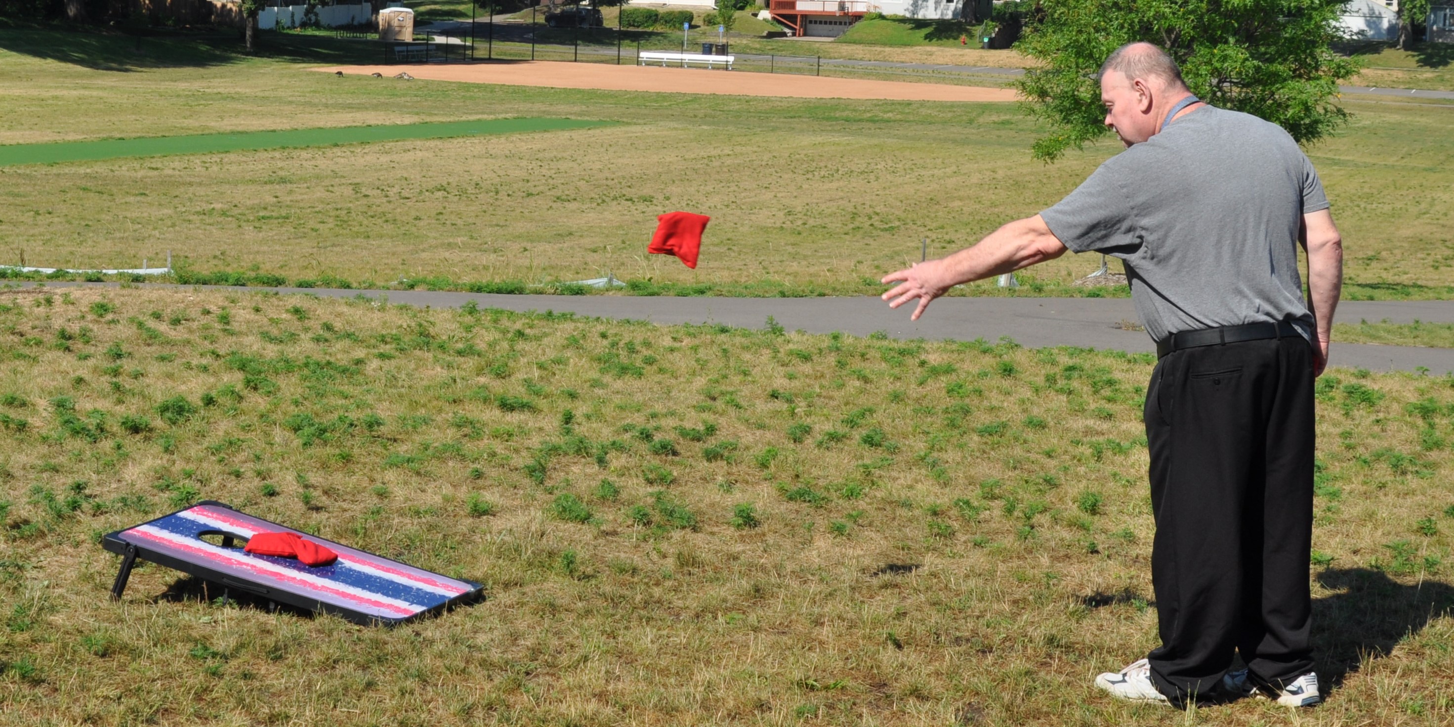 Photo of adaptive participant playing bags or cornhole