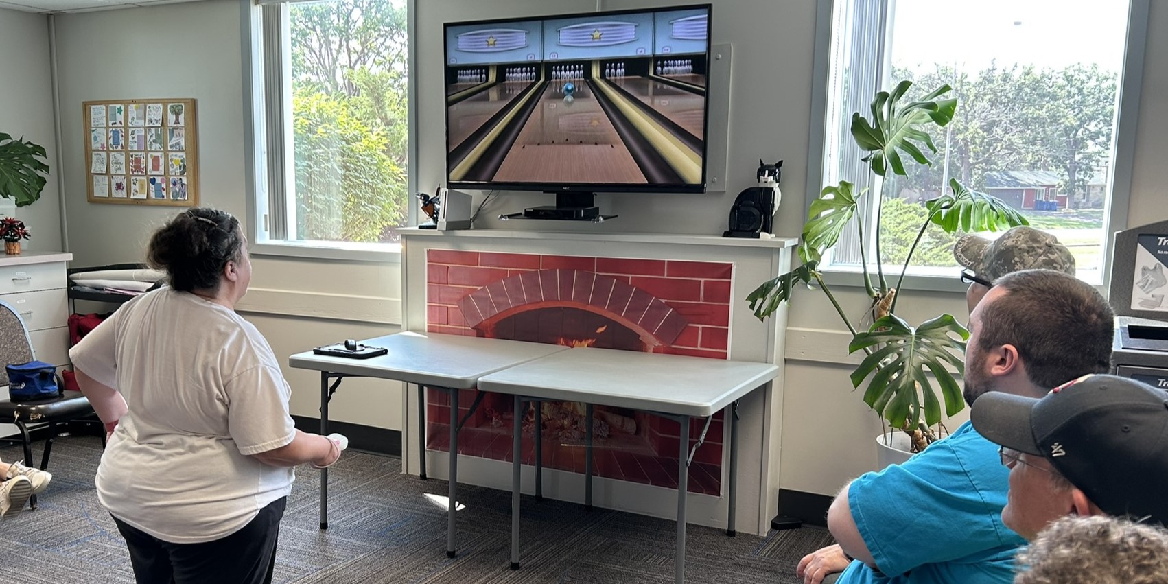 Adaptive Recreation participants playing Nintendo Wii bowling videogame