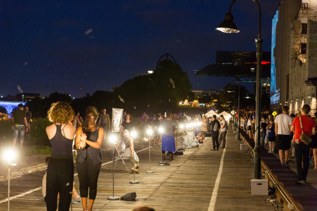 Outdoor evening scene full of artsy people.