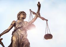 Statue holding scales symbolizing justice. 