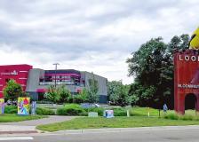 colorful utility boxes in front of red and grey builiding with Goldfinch Sculpture sign on right