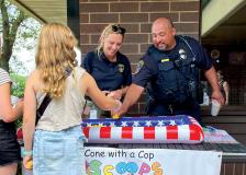 Bloomington Police staff and officers speak with community members at a Cops and Cones event in 2025.