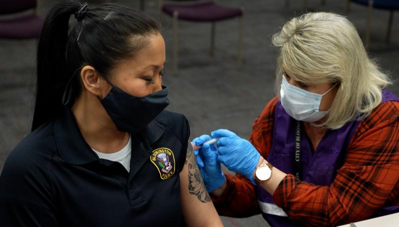 Public Health Nurse giving a COVID-19 vaccine to an individual
