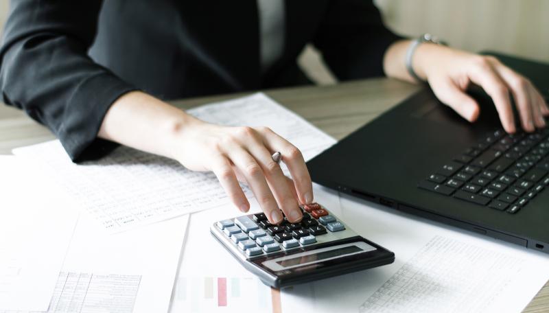 Person doing finances. (c) BigStockPhoto.
