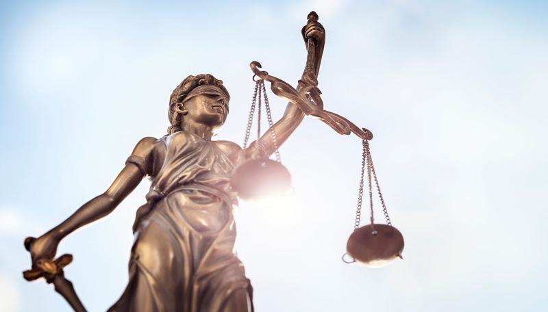 Statue holding scales symbolizing justice.