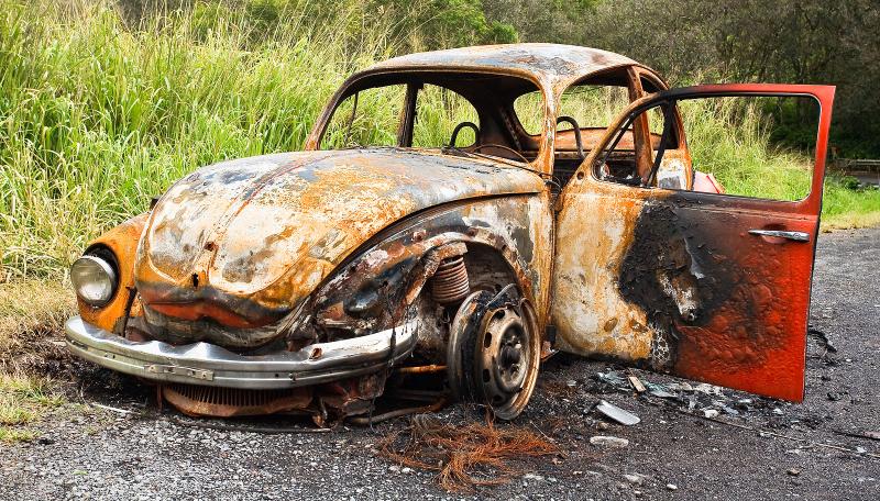 A rusty, broken-down car. 