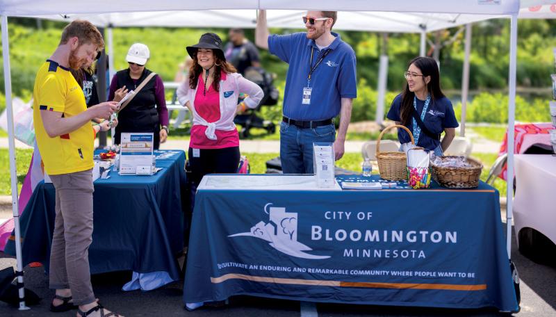 Finance employees tabling a city event