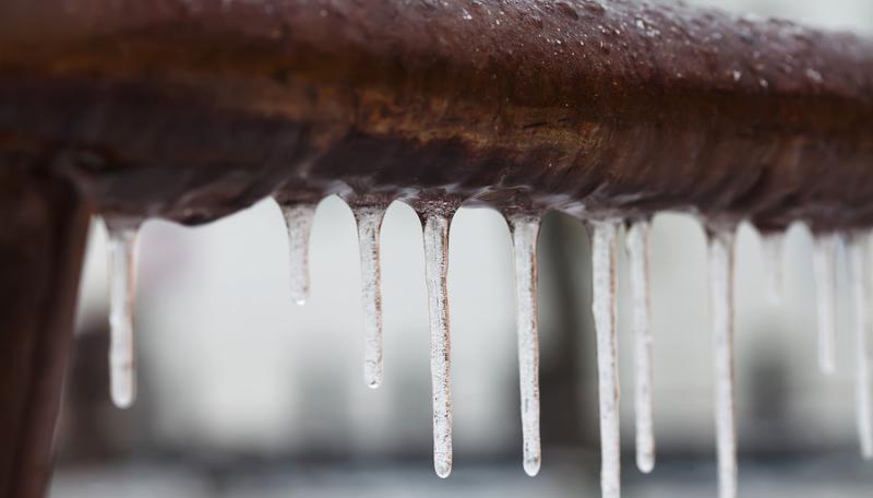 bigstock--162588956.jpg Frozen water pipe with icicles.