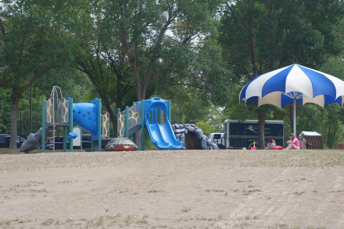 Bush Lake Beach playground, umbrella, Parks and Recreation trailer