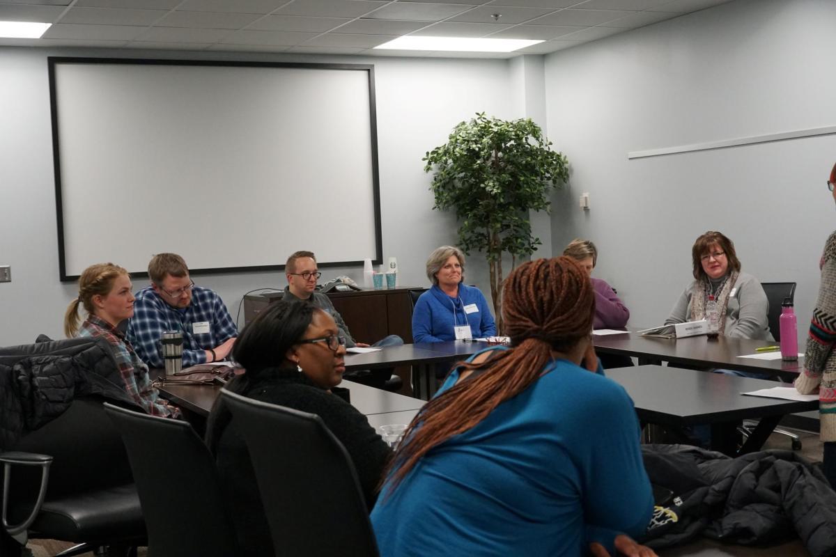 A Bloomington Leadership Group sits in a conference room