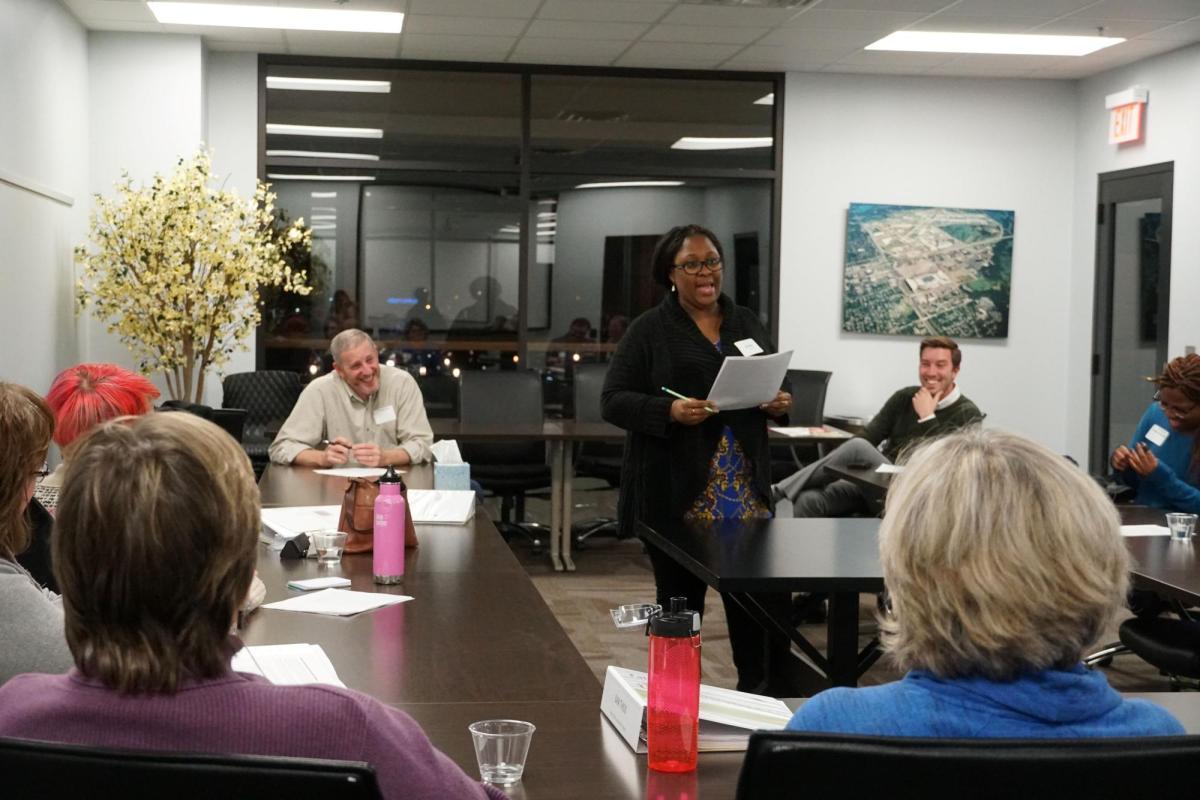 A Bloomington Leadership Program participant presents in front a group in a conference room