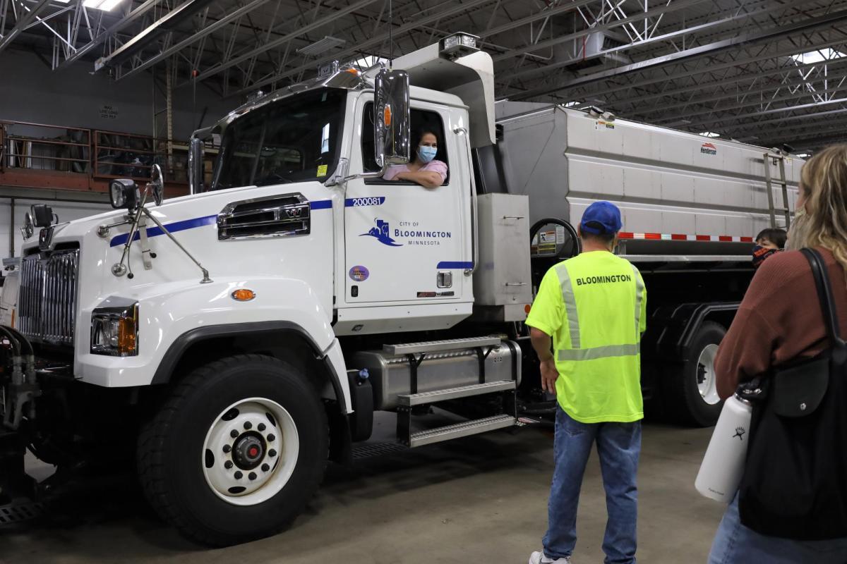 A participant sits in a large City of Bloomington truck and looks out the window