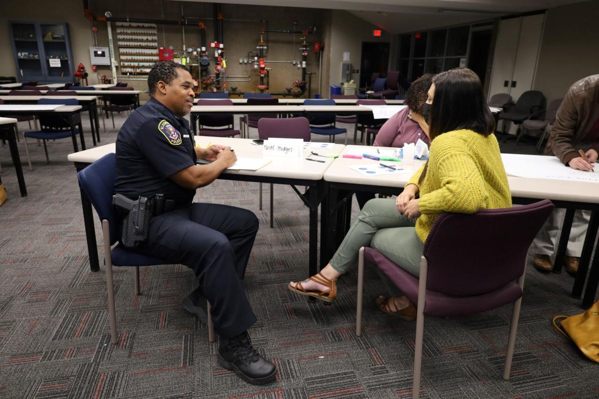 A Bloomington Leadership Program participant sits and talks with the Chief of Police