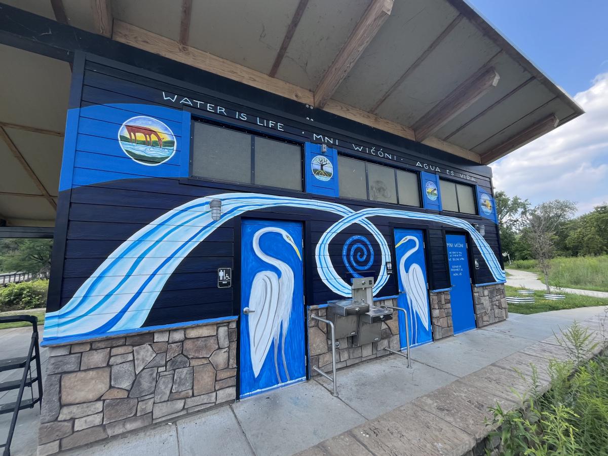 Colorful mural on wall and public restroom doors