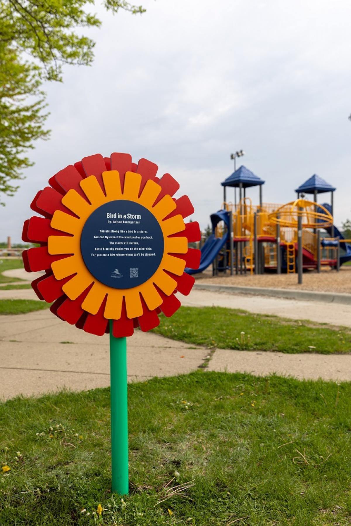 Hometowrn Poetry artistic flower sign with a poem printed on the facade.