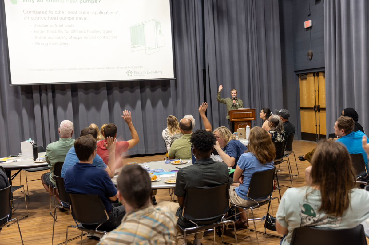 People seated, listening to a presentation