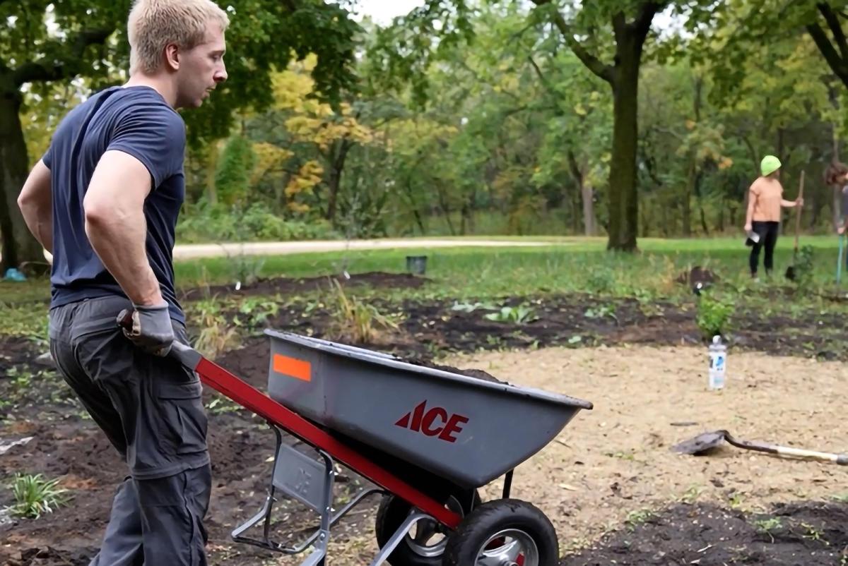 Man pushes wheelbarrow during planting event at Indigenous Botanical Garden September 2026