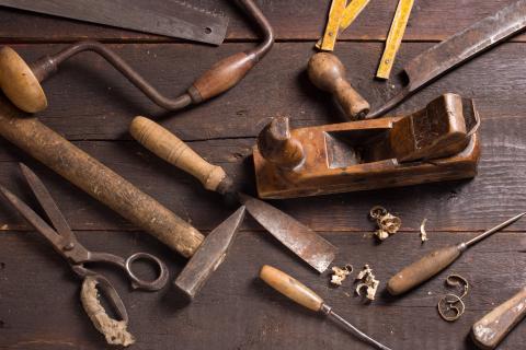 A selection of hand tools including hammers, saws and chisels.