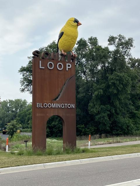 Goldfinch sculpture by Donald Lipski, with South Loop signage