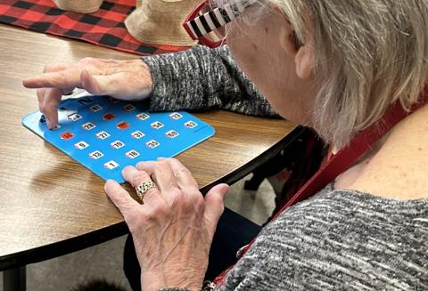 Older adult playing bingo.