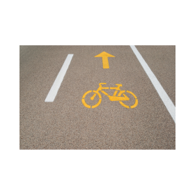 yellow bike stencil and arrow painted on road 