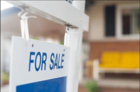 Blue and white for sale sign in front of house